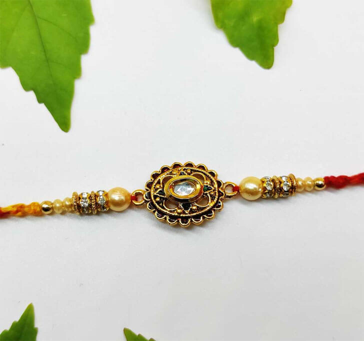 Buy Golden Designer Diamond Stone Center Piece Bhaiya Rakhi