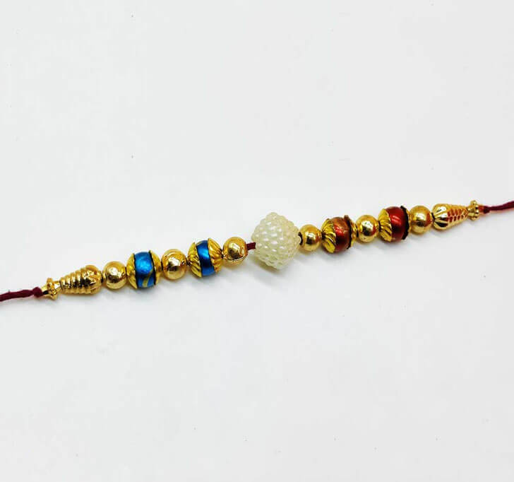 Buy Golden Beads White Pearl Center Piece Bhaiya Rakhi