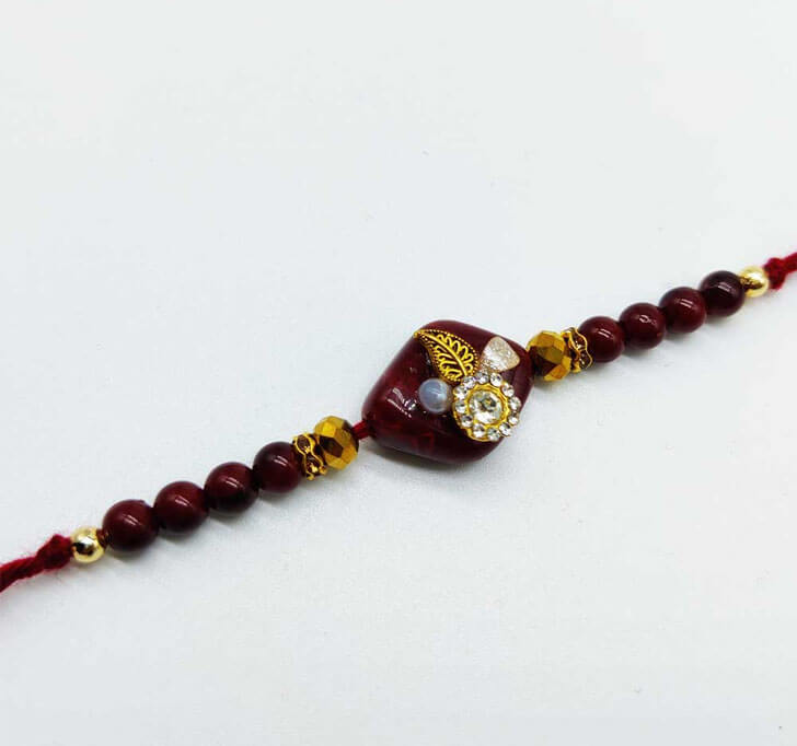 Buy White Diamond Maroon Designer Beads Bhaiya Rakhi