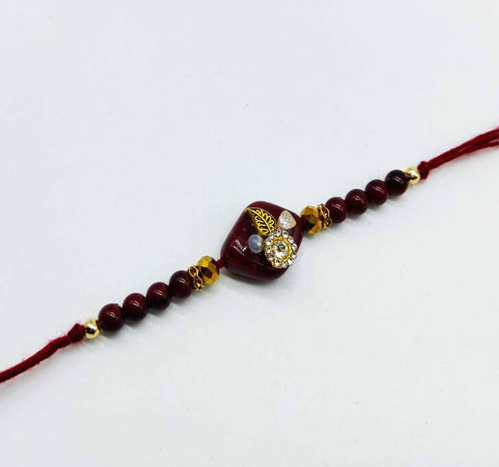 Buy White Diamond Maroon Designer Beads Bhaiya Rakhi